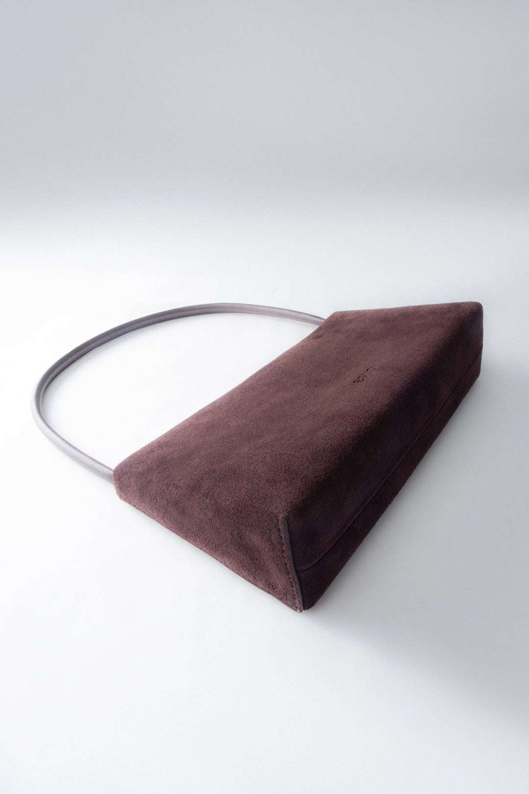 Schrägansicht der flach liegenden Tasche, die das minimalistische Design und die Tiefe zeigt