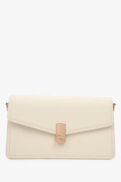 Klassische Vorderansicht der milchbeigen Ledertasche mit goldfarbenem Verschluss.