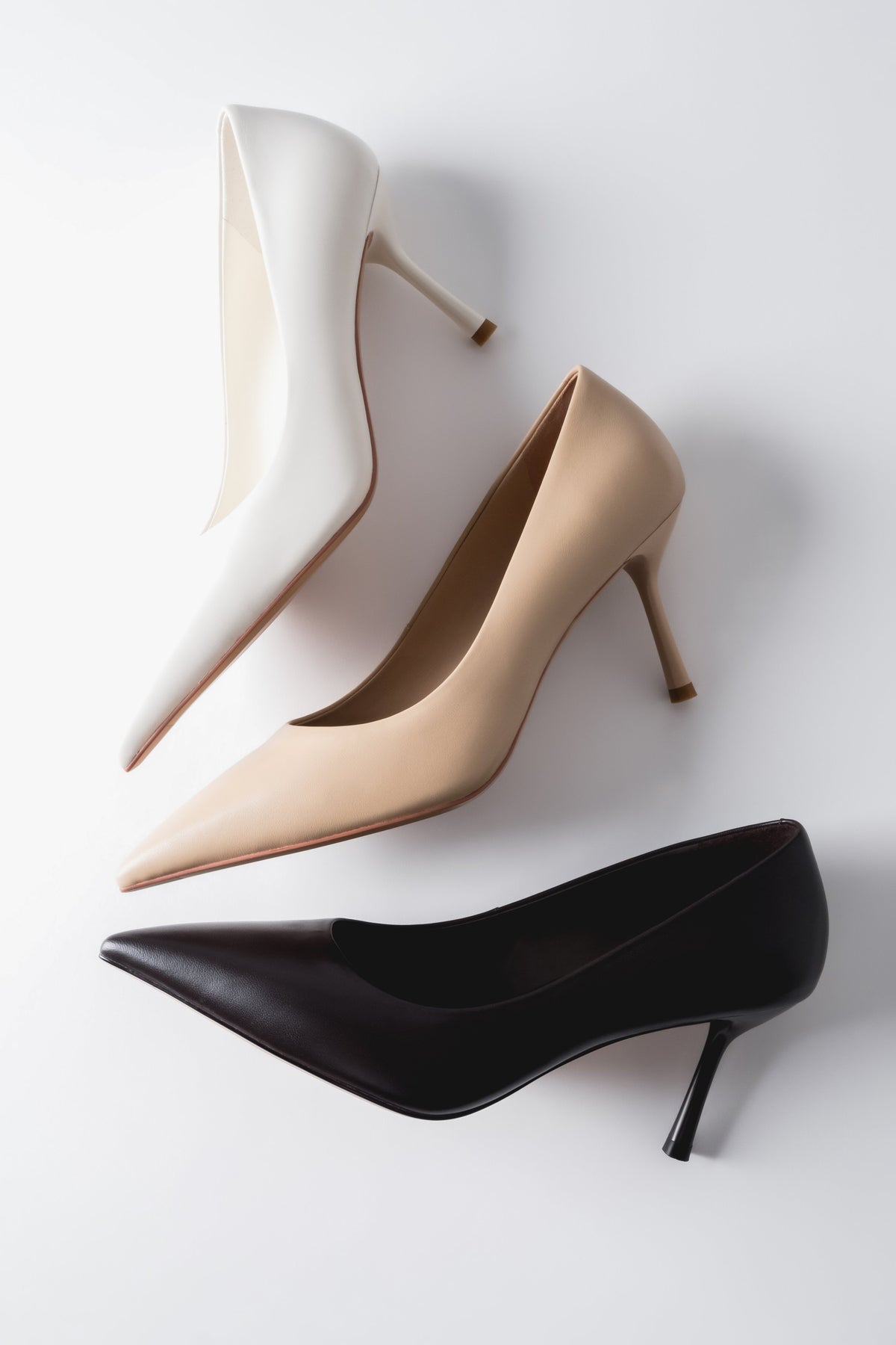 Kreative Draufsicht auf mehrere Farbvarianten der Stilettos im Studio-Setup 