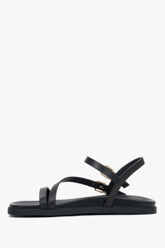 Seitenansicht der flachen schwarzen Leder-Sandalen für Damen.