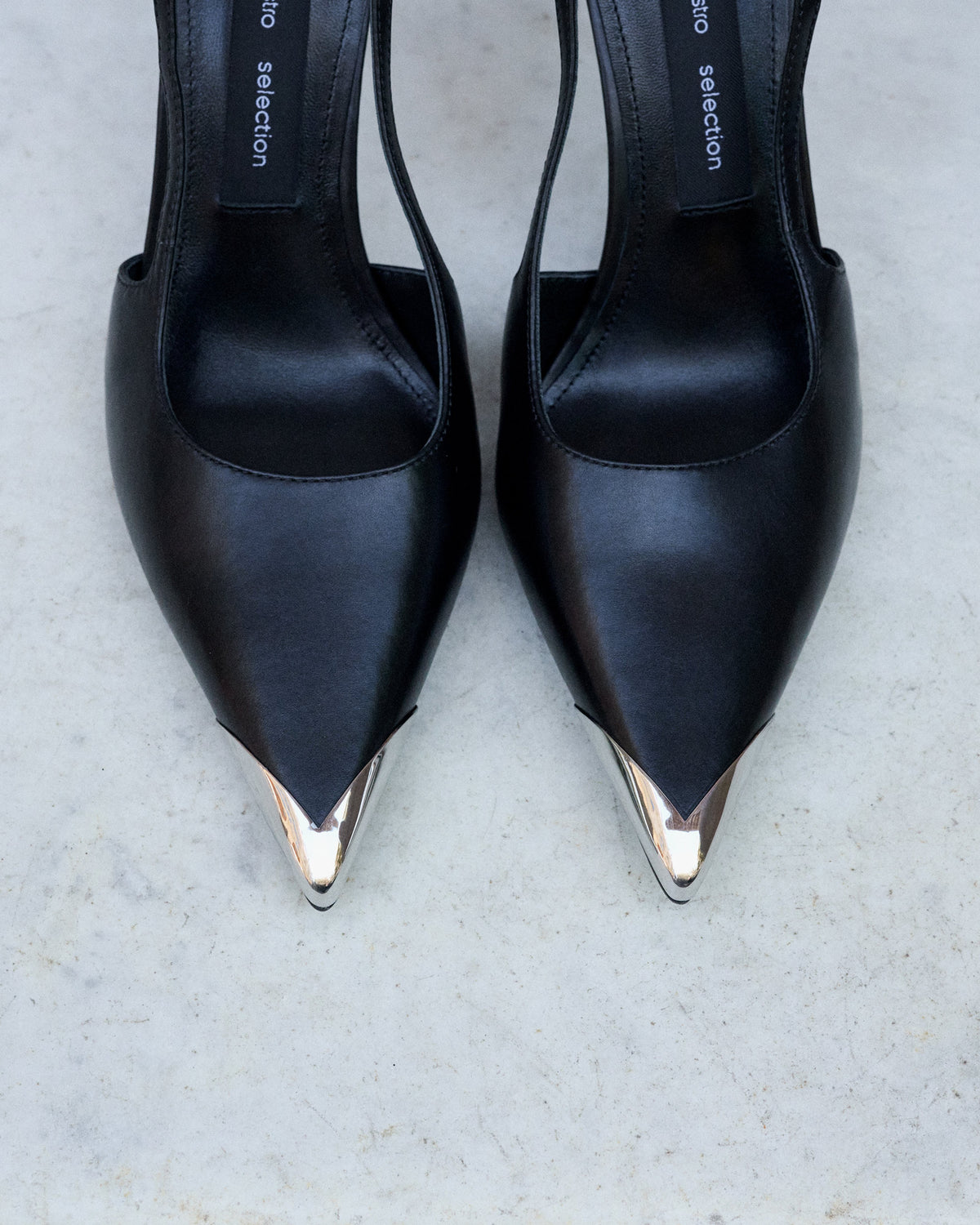 Schwarze Damen-Slingpumps von oben mit spitzer silberfarbener Schuhspitze