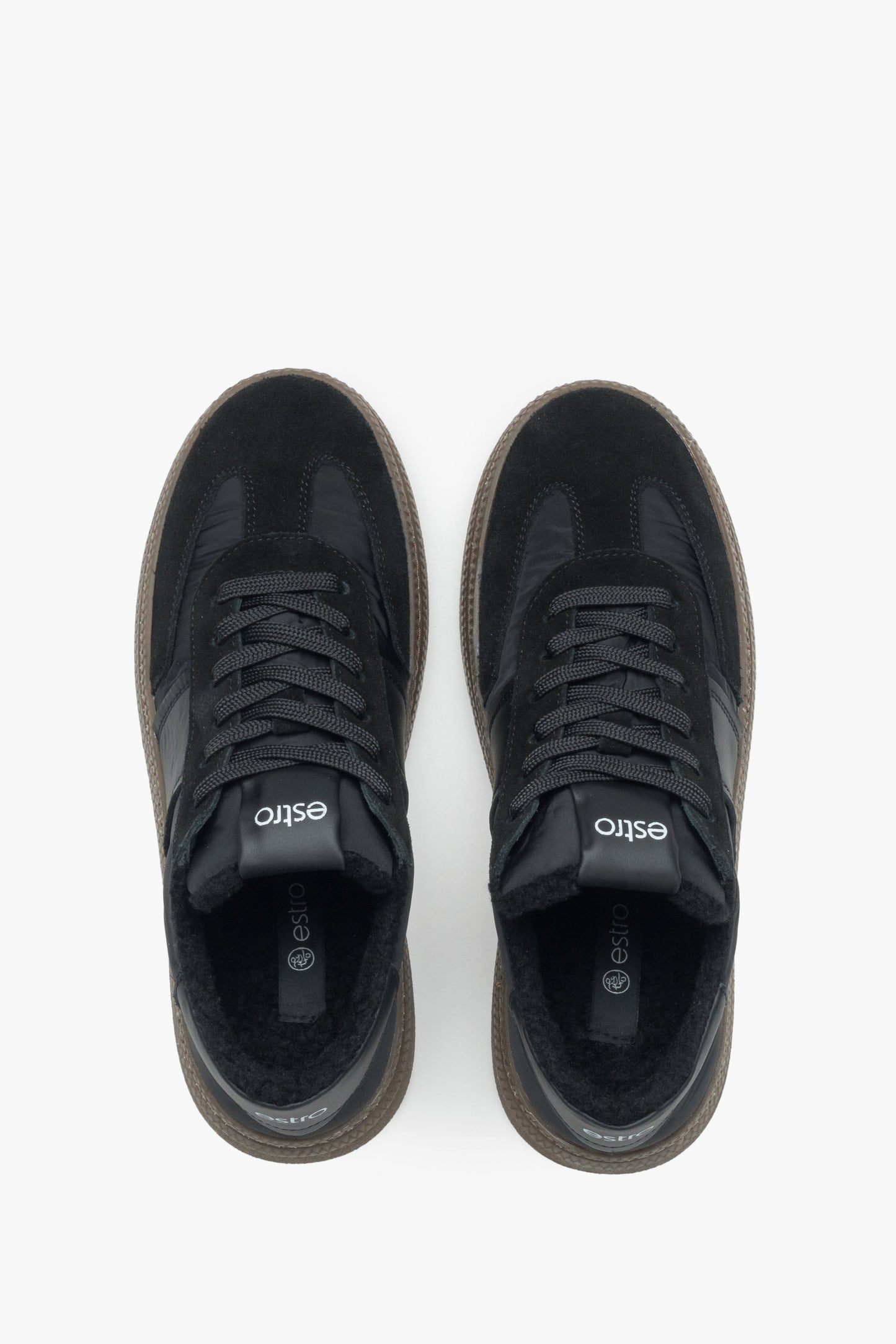Draufsicht direkt von oben auf die schwarzen Sneaker und das warme Kunstfell-Futter