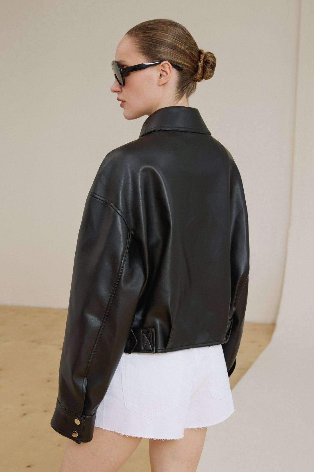 Schwarze Oversize-Damen-Jacke aus Kunstleder in der Rückansicht