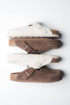 Kombination aus weißen und braunen Damen-Clogs aus weichem Naturvelours.